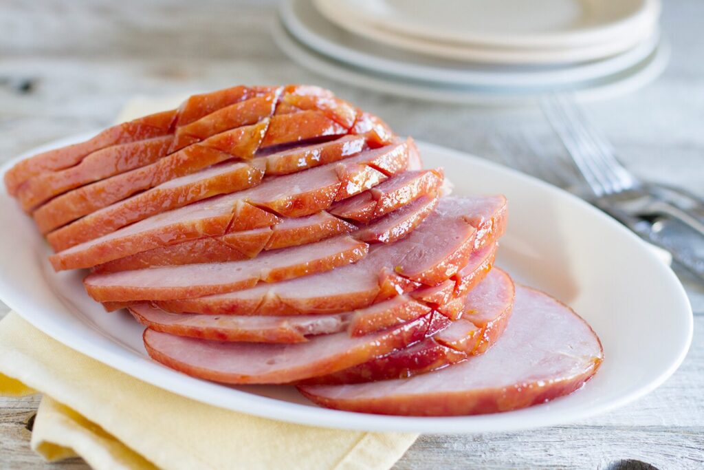 Apricot honey glazed ham on a serving platter