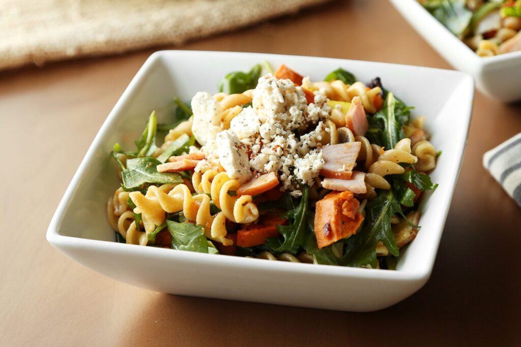 Pasta salad with roasted sweet potatoes, Canadian bacon, arugula, and feta cheese