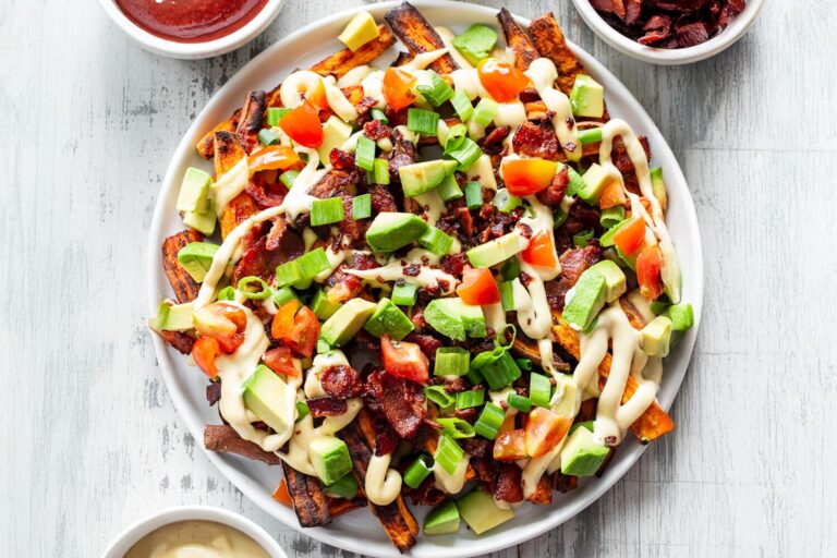 Sweet Potato Fries with bacon, dairy-free cheese sauce, avocados, and tomatoes.