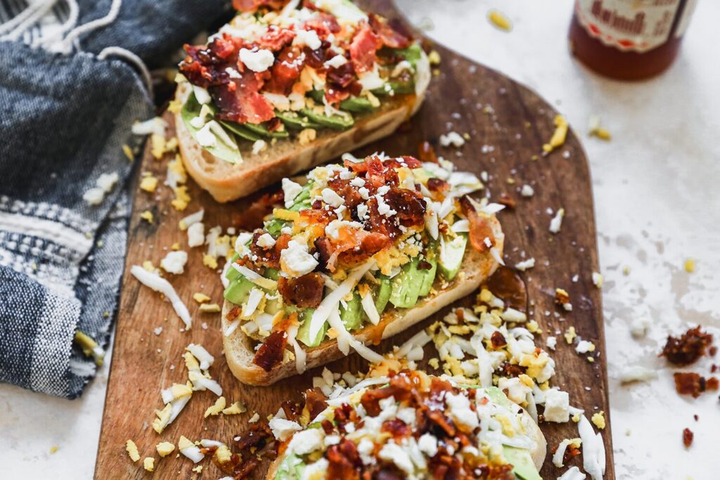 Avocado toast topped with bacon and hardboiled egg