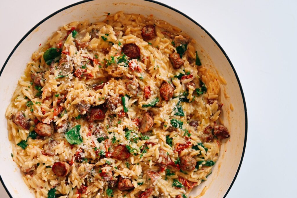 Orzo with chicken sausage, sun dried tomatoes, and a creamy sauce.