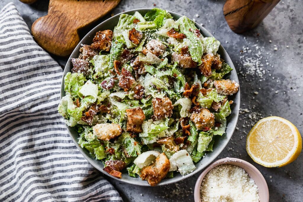 A bowl of bacon Caesar salad