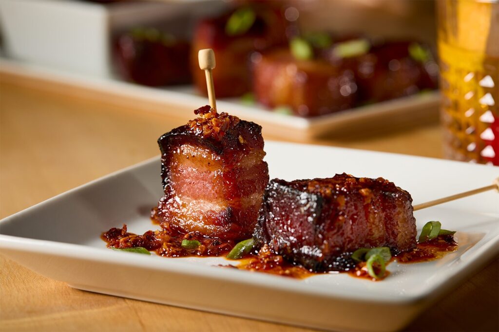 Two Hot Honey and Chile Glazed Bacon Bites on a plate