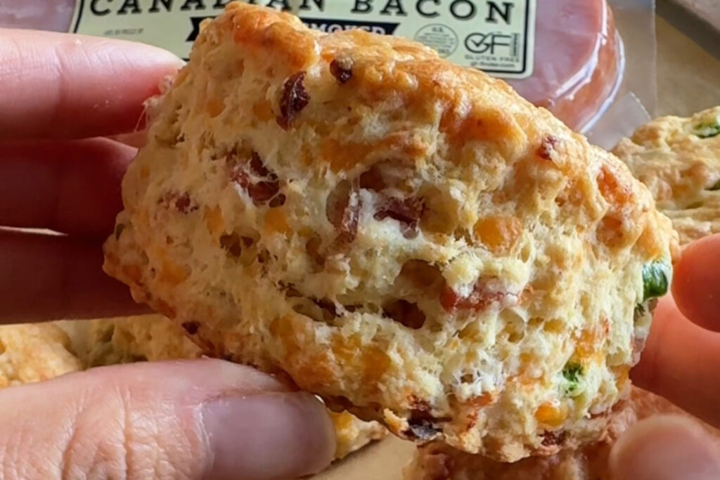 Up close shot of a biscuit, with Jones Dairy Farm Canadian Bacon and jalapenos.