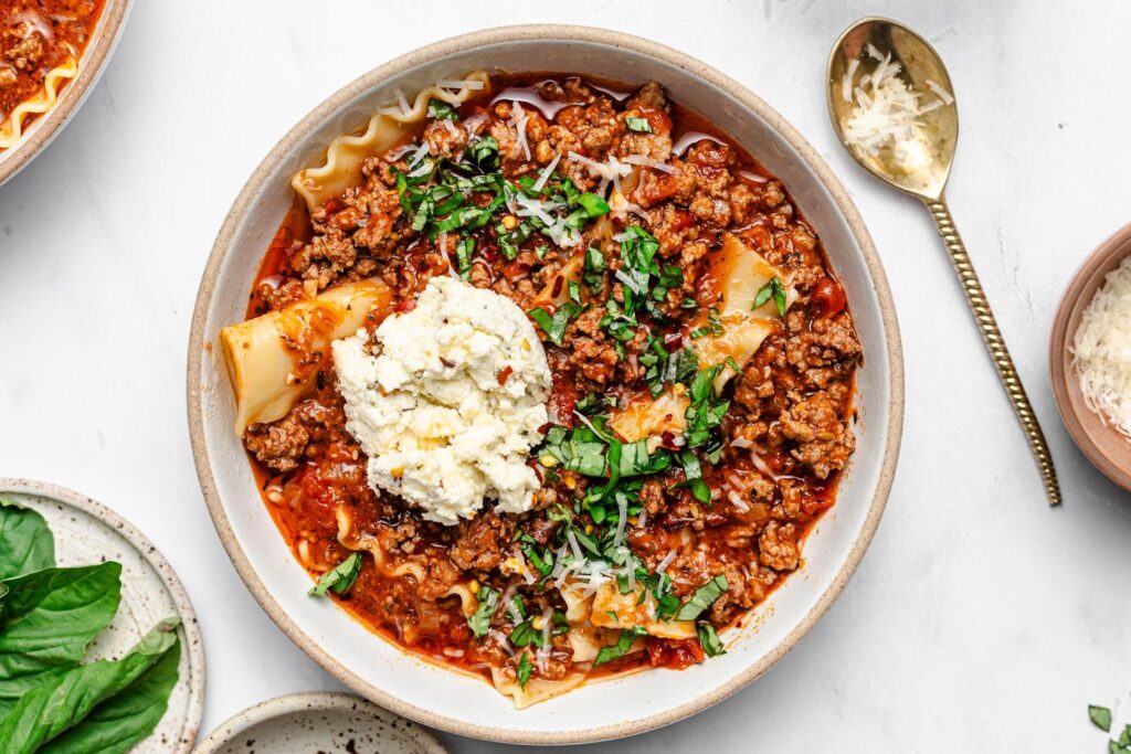 A bowl of lasagna soup with Jones Diary Farm All Natural Pork Sausage Roll.