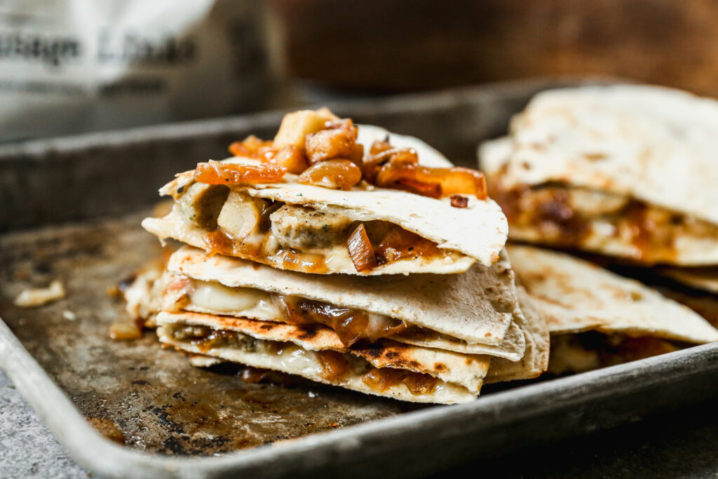 Quesadillas with Jones Dairy Farm chicken sausage, caramelized onions, apples, and fontina cheese.