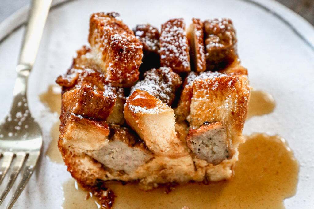 A slice of a sausage French toast bake on a plate.